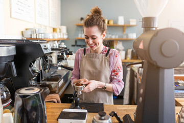 Female barista making coffee 