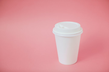 Cup of coffee to go on living coral background.