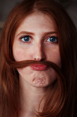 funny red-haired girl with a mustache