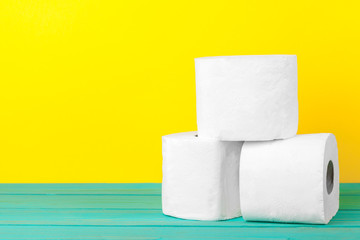 Toilet paper stacks  on bright yellow background