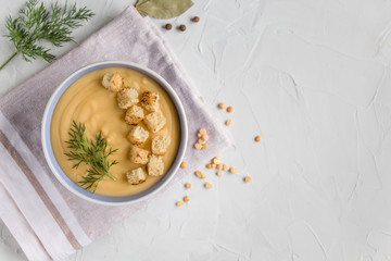 pea cream soup with croutons on a light background. The view from the top . Copy space