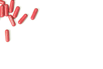 Red pills on white with copy space, blurry