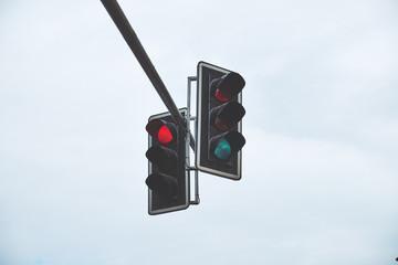 two traffic lights against the blue sky
