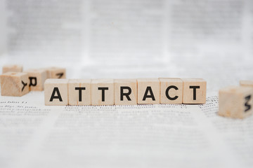 ATTRACT Word Written In Wooden Cube