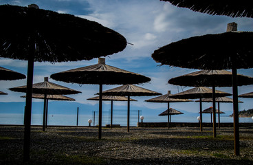 Umbrellas at a beach bar. Wooden, old, beach umbrellas at an abandoned lake beach bar.