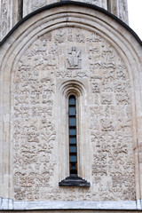 Exterior architectural decorations  St. Demetrius Cathedral, Vladimir, Russia. White stone carving on south wall of the church. sculptural panel framing lancet window. Front view close up
