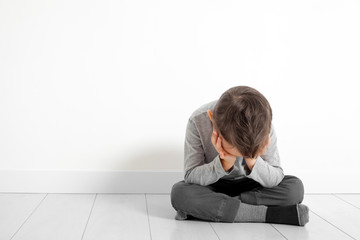 a child whose depression is sitting on the floor