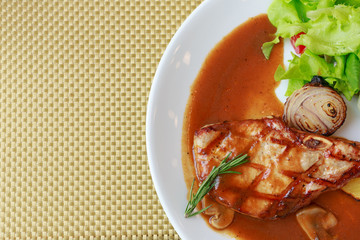 grilled pork chop with vegetable on disk