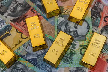 Golden bullion at australian dollar banknotes close up
