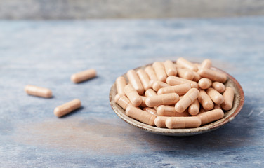 Cat's Claw (Uncaria tomentosa)  Extract Capsules. A Dietary Supplement. Immune System Support. Rustic wooden background. Close up. Copy space. 