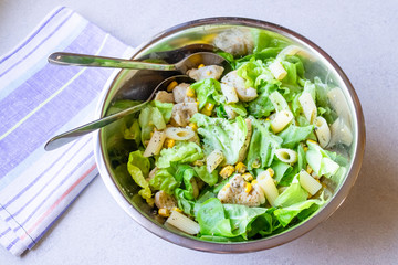 Salad with fried chicken, sweet corn and pasta