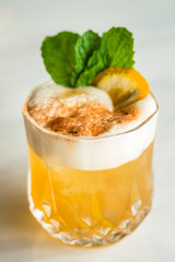 Cocktail with orange bitter and orange peel and mint leave