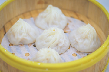 Xiao Long Bao Dumpling in bamboo basket with meat and soup inside