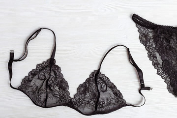 Top view Black Lace lingerie set on white wood. Beautiful women's underwear.
