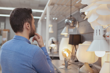 Handsome man shopping at furnishings store
