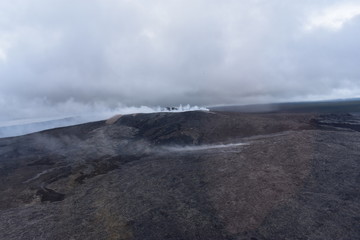 Arial View of Mauna Loa Volcano Crater Hawaii smoke rising from the crater as it is errupting