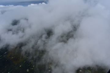 Arial view of Hilo Hawaii from above the clouds. Tourism showing the city from a helicopter