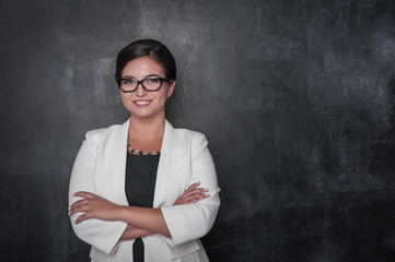 Happy smiling teacher with eyeglasses on blackboard