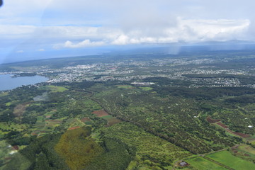 Arial View of Hawaiian Rainforest and waterfalls amid a dense tropical rainforest with rivers and valleys zig zagging across the land