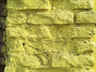 Textured abstract background old yellow brick wall dirty vintage sunny day