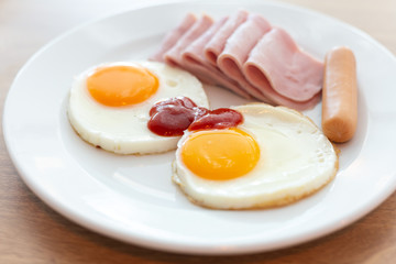 Two fried eggs and sausage for healthy breakfast