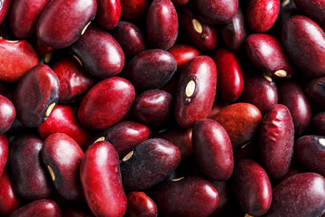 Closeup of a grain of red bean seeds. The texture of the legumes. Close up red beans background, seeds of red beans