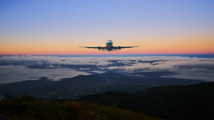 Fototapeta na wymiar airplane on the skyline and sunrise landscape cloud and hill