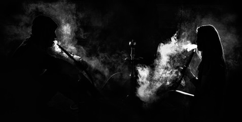 A girl and man sitting in smoke with backlight. © Евгений Гуляев