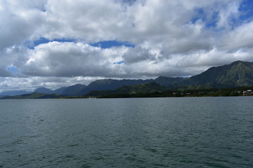 Mountains along the Pacific Ocean. Dense jungle growing around and up the steep slopes under a beautiful blue sky