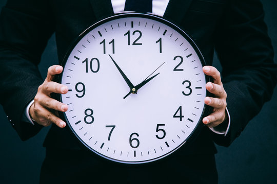 Business man hand with clock,business time, business time management,start up business.