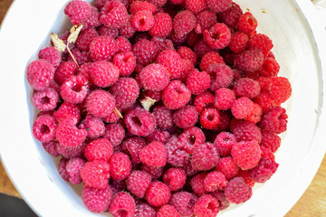 Fresh red raspberry in white bucket bright
