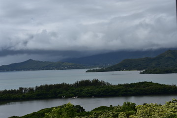 Mountainside View of Pacific Ocean in hawaii. Clouds rolling in as the jungle disperses into sea