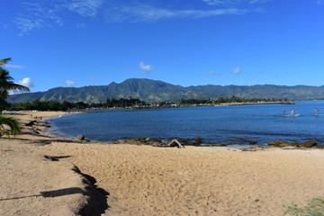 Mountains along the Pacific Ocean. Dense jungle growing around and up the steep slopes under a beautiful blue sky