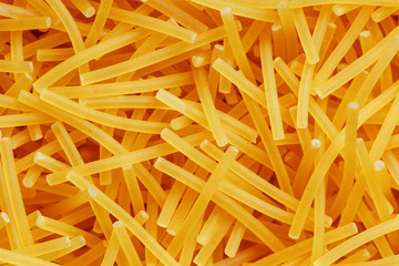 Background texture and pattern of boiled egg noodles or spaghetti pasta in full-frame format. View from above. Close-up