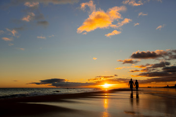 happy couple walking on seashore on a beach vacation or honeymoon trip - 260554793