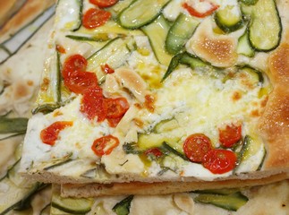 pizza with fresh tomato zucchini and mozzarella cheese