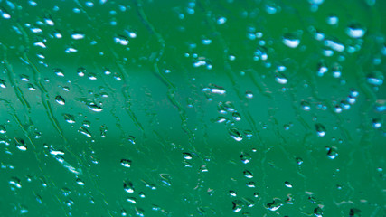 Rain Drops Relecting on Window Glass