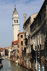 Fototapeta premium Canal and church tower in Venice, Italy