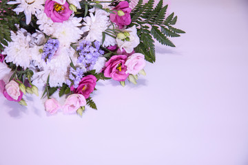Obraz na płótnie Canvas A modern, beautiful floral bouquet on a purple background.