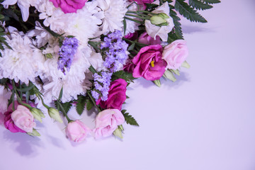 A modern, beautiful floral bouquet on a purple background.