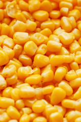 Golden canned corn, as distributed on a plane background and texture of popcorn. Before watching a movie top view. Close-up