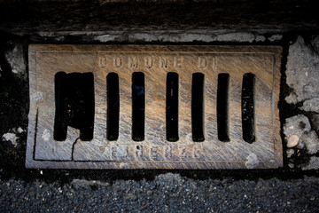 Old and damaged sewer in a urban floor in Firenze, Italy