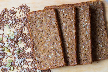 Freshly baked bread from wholemeal and flaxseed, sunflower seeds, pumpkin seeds. Healthy eating concept.