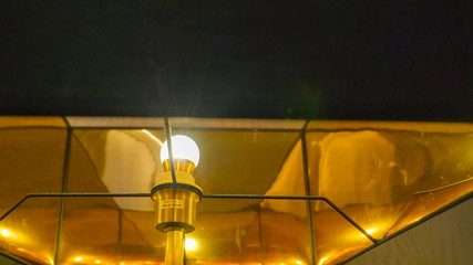 13284_The_bulb_inside_the_gold_lampshade_in_the_room.jpg