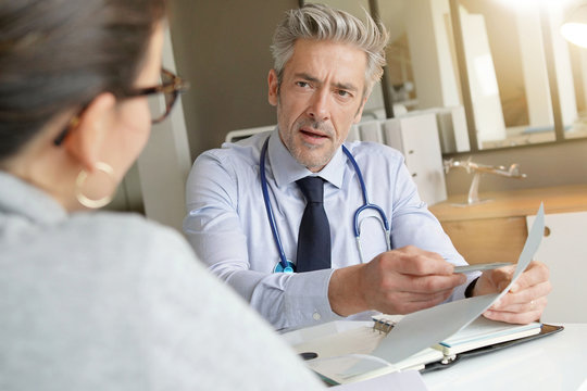Doctor going through results with patient in clinic office