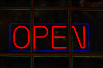 Neon red sign with the word open.