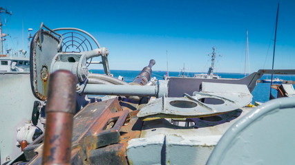 The rusty ammunitions on the top of the deck of the ship