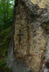 The stone walls of the ancient castle on a background of blue sky and the spring landscape