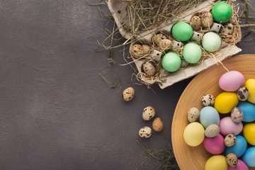 Easter background. Colored eggs on gray stone surface