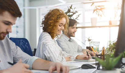 Young millennial people working in coworking space
